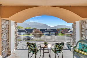 View of patio with a residential view, a balcony, and a mountain view