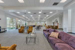 Carpeted clubhouse  with visible vents and a drop ceiling