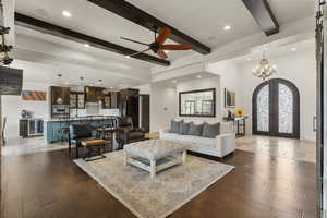 Living area with recessed lighting, french doors, beamed ceiling, and ceiling fan with notable chandelier