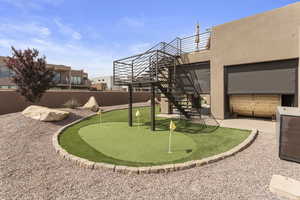 View of yard with a patio, stairs, and fence