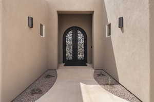 Entrance to property featuring stucco siding