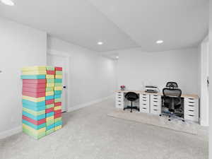 Office area with carpet flooring, and recessed lighting