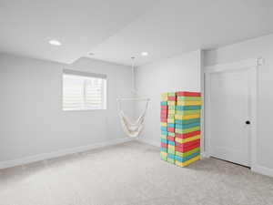 Recreation room featuring recessed lighting, carpet flooring, and swing