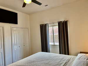 Bedroom featuring a ceiling fan and two closets