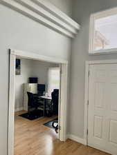 Home office with wood finished floors and baseboards