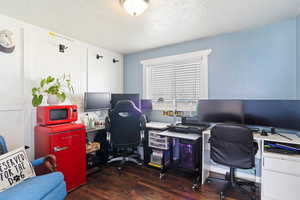 Home office featuring wood finished floors and a textured ceiling