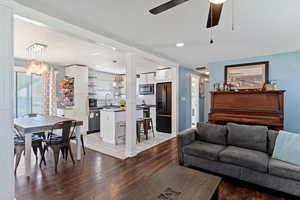 Living room with recessed lighting, light wood-type flooring, a textured ceiling, and a ceiling fan