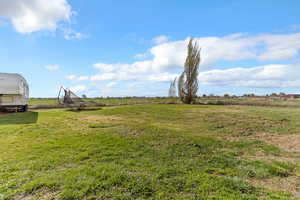 View of yard featuring a rural view and a trampoline