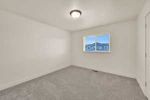 Unfurnished room featuring light carpet, baseboards, and visible vents