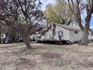 Rear view of house with a wooden deck