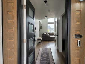 Hallway with baseboards and wood finished floors