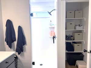 Full bath featuring vanity and a stall shower