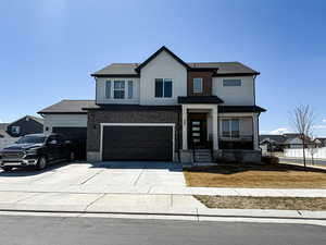 View of front of home featuring covered porch, concrete driveway, a garage, a shingled roof, and stucco siding