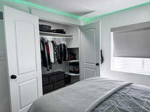 Bedroom featuring a textured ceiling and a closet