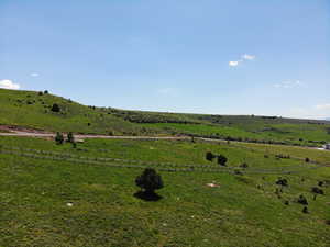 View of yard with a rural view and fence