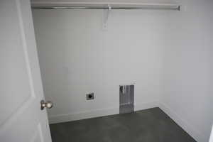 Laundry room featuring hookup for an electric dryer, laundry area, and baseboards