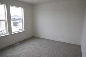 Unfurnished room with baseboards, visible vents, and carpet flooring