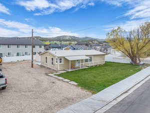 Ranch-style home with fence, metal roof, a mountain view, and a residential view