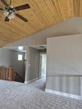 FamilySwing room featuring lofted wood plank ceiling, carpet floor with a ceiling fan and an overlook to mainfloor, view wiindows could easily be divided into another bedroom with a talk in closet plus a study