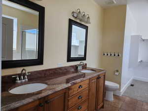 Master bathroom featuring double vanity with granite countertops