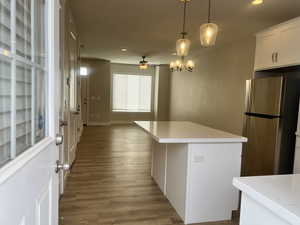 Kitchen featuring a ceiling fan, wood finished floors, recessed lighting, and freestanding refrigerator