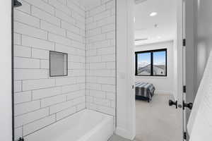 Bathroom featuring shower / bathtub combination, baseboards, recessed lighting, and ensuite bathroom