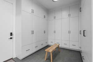 Mudroom with dark tile patterned floors