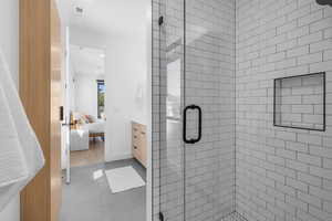 Ensuite bathroom featuring a shower stall, ensuite bath, tile patterned flooring, and vanity