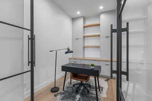Office area with recessed lighting, light wood-type flooring,