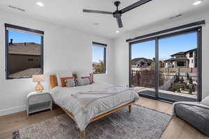 Bedroom featuring wood finished floors, visible vents, and recessed lighting