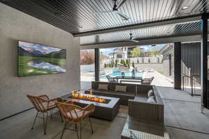View of patio / terrace with a fenced backyard, an outdoor living space with a fire pit, a fenced in pool, and ceiling fan