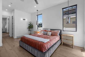 Primary Bedroom featuring light wood-type flooring, baseboards, and recessed lighting