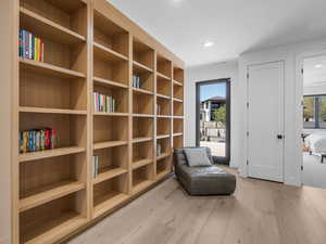 Sitting room featuring wood finished floors and recessed lighting.Entrance to large  outdoor living area