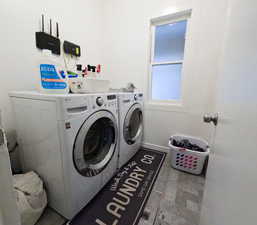 Clothes washing area featuring separate washer and dryer and laundry area