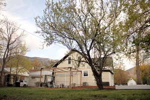 Exterior space with central air condition unit, a lawn, entry steps, and a mountain view