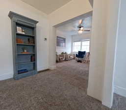 Living area with baseboards, carpet flooring, and ceiling fan