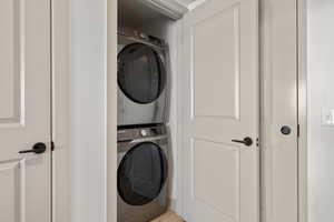 Laundry area with stacked washer and dryer