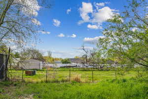 View of yard featuring fence
