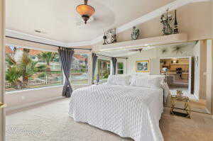 Carpeted bedroom with crown molding and baseboards