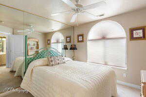 Bedroom featuring carpet floors and baseboards