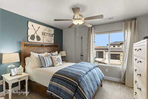 Bedroom featuring carpet floors, visible vents, a ceiling fan, and baseboards