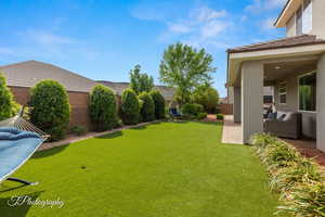 View of yard with a fenced backyard, an outdoor living space, and a patio