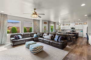Living area featuring visible vents, recessed lighting, ceiling fan, and dark wood-style flooring