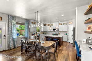 Dining room with recessed lighting, visible vents, and dark wood-style floors