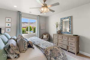 Bedroom featuring a ceiling fan, light colored carpet, baseboards, visible vents, and recessed lighting