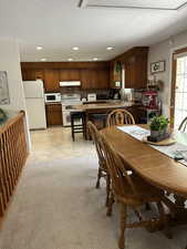 Dining space with a textured ceiling and recessed lighting