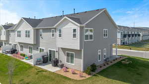 Back of house featuring a patio area, a lawn, and central AC unit