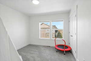 Playroom with carpet floors, visible vents, and baseboards