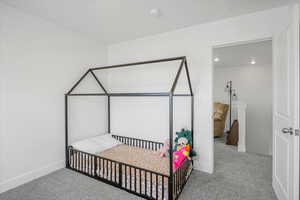 Carpeted bedroom with baseboards