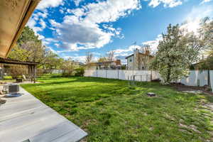 View of yard with a patio area, a fenced backyard, and central AC unit